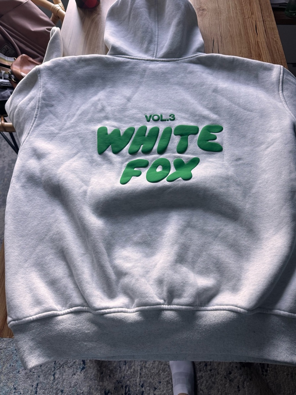 White Fox hoodie gray with green letters.